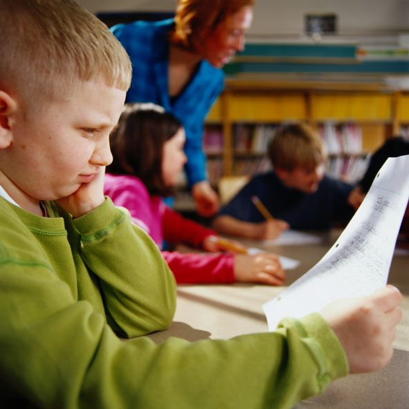 Boy in school looking puzzled