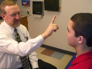 Dr. Karl Klamar of Nationwide Children's Hospital conducts a routine post-concussion exam.