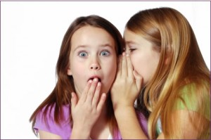 2 girls sharing a secret
