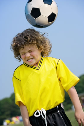 boy heading a soccer ball