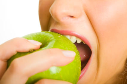 Woman biting green apple Woman biting green apple