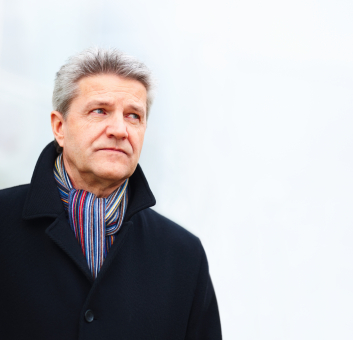 Senior man wearing jacket and muffler around neck