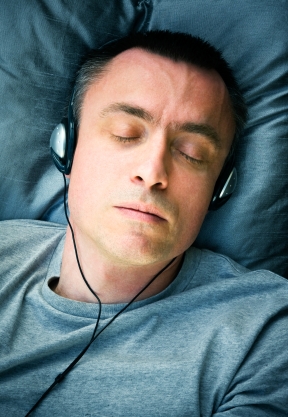 man sleeping listening  to  music