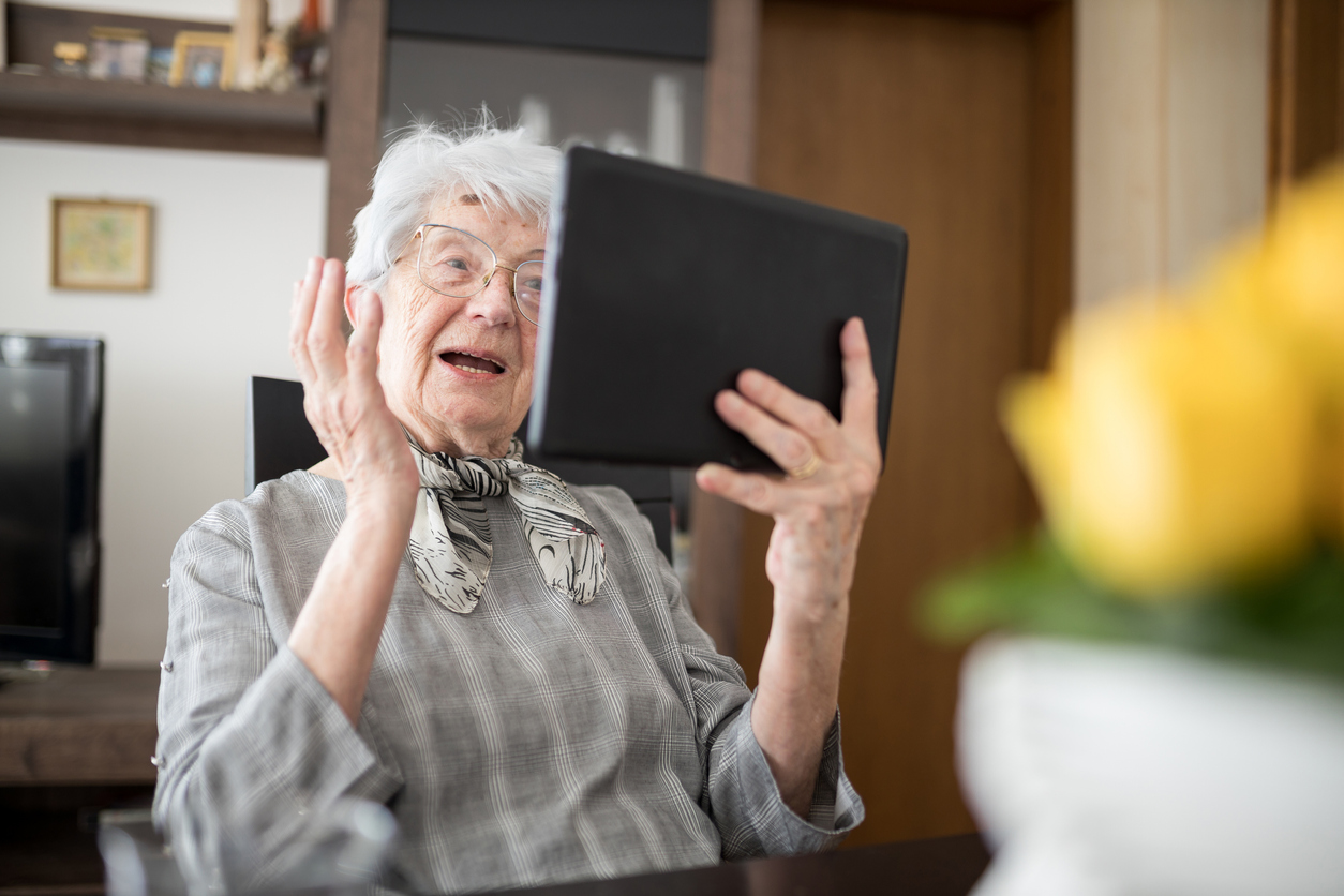 senior holding an ipad
